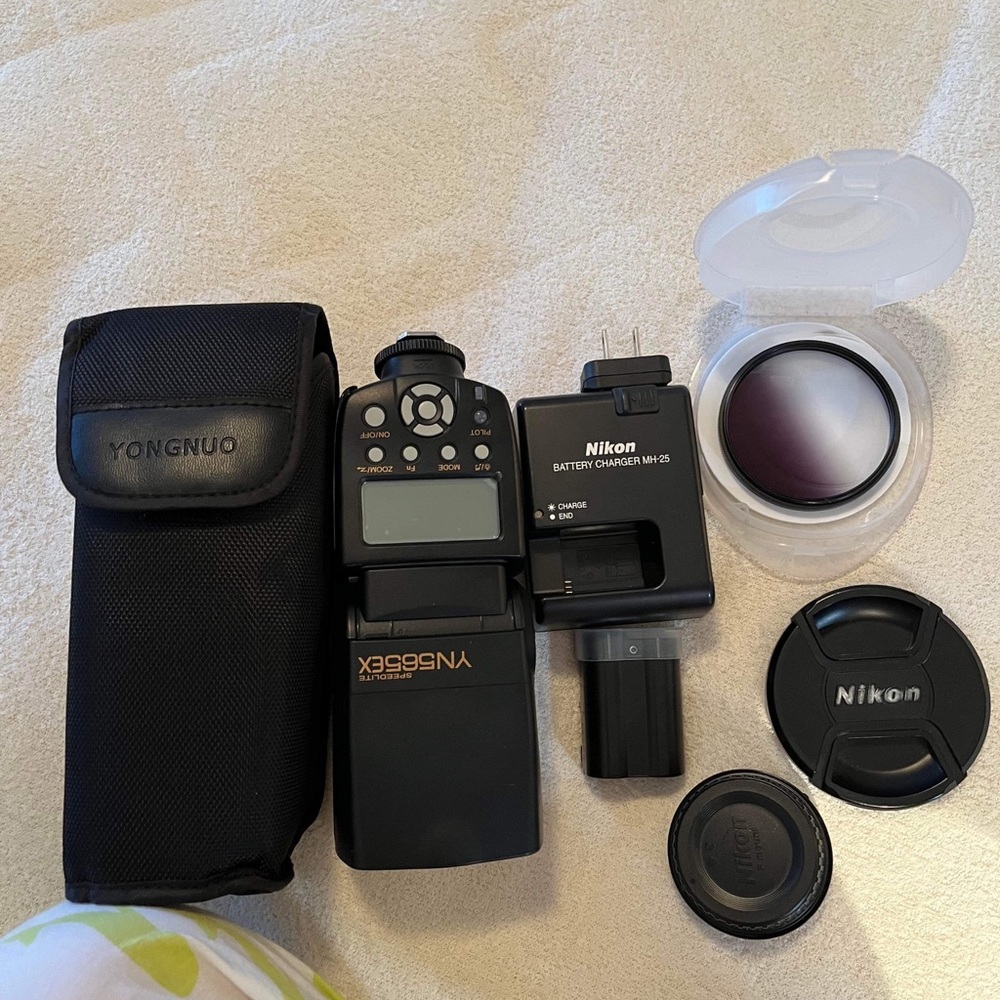 Nicon Camera lense , battery , charger.